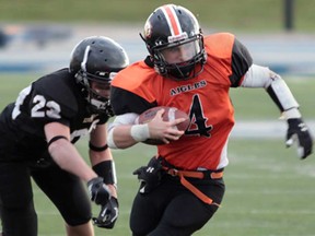 L'Essor's Matt Marentette, right, runs against Riverside during the WECSSAA football semifinal at Alumni Field at the University of Windsor on November 7, 2013.  (JASON KRYK/The Windsor Star)