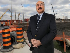 Retired University of Windsor business professor Alfie Morgan believes the Herb Gray Parkway, under construction behind him in this photo, and new border bridge will spawn new businesses.    (DAN JANISSE/The Windsor Star)