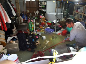 Plumber Dean Grant works to clear a flooded basement on Pacific Avenue after rain caused flooding in several areas of Amherstburg on Tuesday, August 9, 2011. (TYLER BROWNBRIDGE / The Windsor Star)