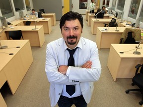Arthur Barbut, managing director of the Downtown Windsor Business Accelerator, stands in front of some of the desks rented out at the Downtown Windsor Business Accelerator.   (TYLER BROWNBRIDGE/The Windsor Star)