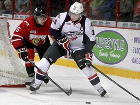 Windsor's Kerby Rychel, right, fights for the puck with Owen Sound's Alex Annecchiarico in OHL action at the WFCU Centre, Saturday, November 2, 2013. (REBECCA WRIGHT/ The Windsor Star)