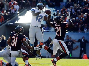 Chicago's Major Wright, right, and Detroit's Jeremy Ross go up for the ball during the first half on November 10, 2013 at Soldier Field in Chicago, Illinois. (Photo by David Banks/Getty Images)