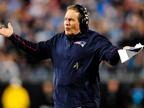 New England coach Bill Belichick looks to the officials for an explanation of a penalty during a game against the Panthers at Bank of America Stadium November 18, 2013 in Charlotte, N.C.  (Grant Halverson/Getty Images)
