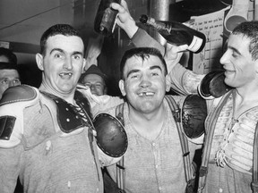 Windsor Bulldogs, Jack  Costello, left, Real Chevrefils and Tom Micallef celebrate after winning the 1963 Allen Cup against the Winnipeg Maroons.