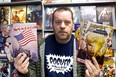 Shawn Cousineau, owner of Rogues Gallery Comics, holds up donated comic books for the fifth annual Goodfellows Comic Book Drive in his store Sunday, Nov. 10, 2013. Cousineau needs 6,000 comic books to make some children extra happy this holiday season. (JOEL BOYCE/The Windsor Star)