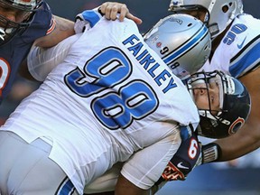 Chicago QB  Jay Cutler, right, is taken down by Detroit's Nick Fairley at Soldier Field on November 10, 2013 in Chicago. The Lions defeated the Bears 21-19. (Jonathan Daniel/Getty Images)