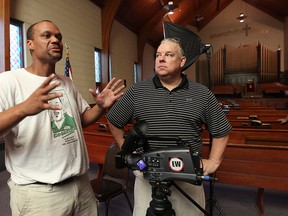 In this file photo from July 2011, Ottawa-based producers Preston Chase, left, and Bob Huggins film a documentary on Emancipation Day at the British Methodist Episcopal Church in Windsor. (DAN JANISSE / Windsor Star files)