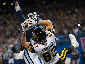 Hamilton Tiger-Cats wide receiver Andy Fantuz, a former Essex Raven, catches the ball for a touchdown past Toronto Argonauts defensive back Jamie Robinson during CFL Eastern conference final in Toronto on Sunday, Nov. 17, 2013. (THE CANADIAN PRESS/Nathan Denette)