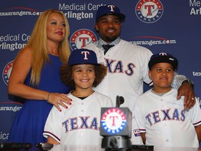Prince Fielder, centre, of the Texas Rangers poses for photos with his wife, Chanel, left. and sons Jaden, front left, and Haven after being introduced as the newest member of the Rangers on November 25, 2013 in Arlington, Texas.  (Ronald Martinez/Getty Images)