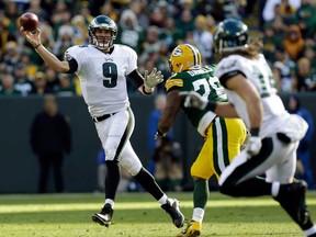 Philadelphia quarterback Nick Foles, left, throws during the first half of an NFL football game against the Green Bay Packers Sunday, Nov. 10, 2013, in Green Bay, Wis. (AP Photo/Mike Roemer)
