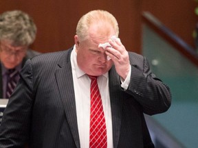 Rob Ford mops his brow at Toronto City Hall on Nov. 18, 2013. (CP)