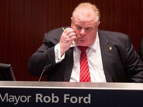 Toronto Mayor Rob Ford sits in the council chamber as councillors look to pass motions to limit his powers in Toronto on Monday November 18, 2013.THE CANADIAN PRESS/Chris Young