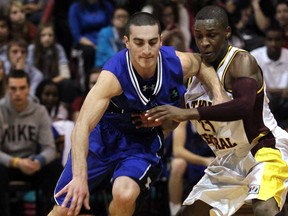 Sarnia St. Christopher's Michael Rocca drives against Catholic Central's Shavon Gayle during last year's Freed's Tip Off Classic boys high school basketball tournament November 30. 2012 in Windsor. (JASON KRYK/ Windsor Star files)