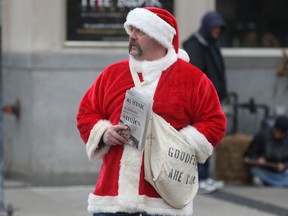 Windsor Goodfellow Jim Romanko sells newspapers at Ouellette and University, Thurs. Nov. 21, 2013, in Windsor, Ont. (DAN JANISSE/The Windsor Star)