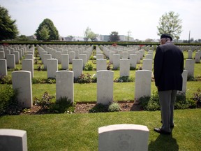 A Normandy veteran looks at the headstones of fallen comrades in Bayeux War Cemetery in Bayeux, France, last June 6 during ceremonies to commemorate the D-Day landings. Canadian war cemeteries in France are kept in pristine condition in honour of those who gave their lives for freedom. (Matt Cardy / Getty Images files)