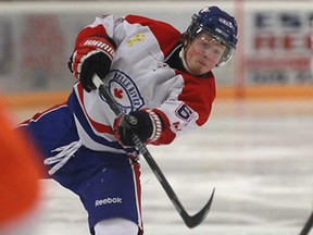 Belle River's Logan Percey, centre, fires the puck against Essex during junior C action at Essex Arena, Tuesday, Nov. 26, 2013. The 73's won 4-2.  (DAX MELMER/The Windsor Star)