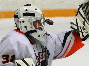 L'Essor goaltender Pierce Dubrowski takes a shot off his mask in game against Holy Names during WECSSAA boys hockey action at Tecumseh Arena Tuesday November 19, 2013. (NICK BRANCACCIO/The Windsor Star)