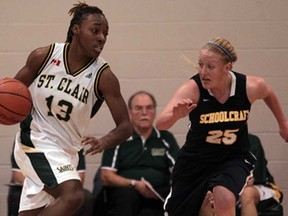 St. Clair's Sasha Senior, left, drives against Schoolcraft's Jessica Parry during OCAA exhibition basketball action at St. Clair College on November 26, 2013 in Windsor. (JASON KRYK/The Windsor Star)