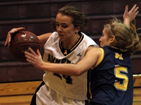 General Amherst's Olivia Starling, left, of drives the baseline against Rachel Dotzert of St. Michael in OFSSA girls basketball action at Catholic Central November 22, 2013.  (NICK BRANCACCIO/The Windsor Star)