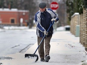 John Shorten shovels the snow off the sidewalk along Brighton Rd. near his Tecumseh Ont. home on Thurs. Nov. 28, 2013.  The city is looking for Snow Angel volunteers to help seniors keep their walkways clear this winter. (DAN JANISSE/The Windsor Star)