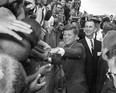 U.S. President John F. Kennedy shakes hands of spectators in Tampa, Fla. on Nov. 18, 1963, where he gave a speech commemorating the 50th anniversary of the first scheduled passenger airplane flight. (Associated Press files)