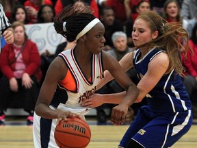 Holy Names' Ayoleka Sodade, left, dribbles against St. Anne's Amanda Milanis in the WECSSAA girls AAAA  basketball championship at Holy Names Wednesday November 6, 2013.  (NICK BRANCACCIO/The Windsor Star)