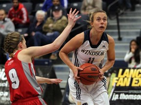 Windsor's  Jessica Clemencon, right, drives to the net against Algoma's Courtney White during OUA women's basketball at the St. Denis Centre, November 22, 2013.  (NICK BRANCACCIO/The Windsor Star)