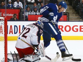 Toronto's James van Riemsdyk, right, deflects a shot on Sergei Bobrovsky of the Blue Jackets at the Air Canada Centre November 25, 2013 in Toronto. (Abelimages/Getty Images)