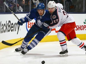 Toronto's James van Riemsdyk, left, holds up Ryan Murray of the Blue Jackets at the Air Canada Centre November 25, 2013 in Toronto. (Abelimages/Getty Images)