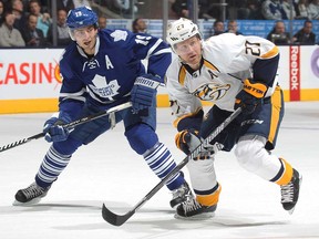 Nashville's Patric Hornqvist, right, jumps into the play against Toronto's Joffrey Lupul at the Air Canada Centre on November 21, 2013 in Toronto, Ontario, Canada. (Claus Andersen/Getty Images)