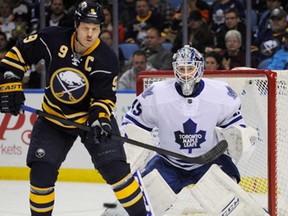 Buffalo's Steve Ott, left, prepares to deflect an incoming shot in front of Toronto's Jonathan Bernier during the first period in Buffalo, N.Y., Friday, Nov. 15, 2013. (AP Photo/Gary Wiepert)