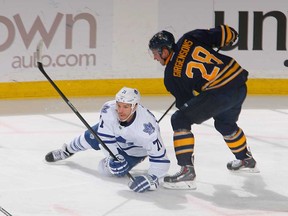 Toronto's David Clarkson, left, falls in front of Buffalo's Zemgus Girgensons at First Niagara Center on November 15, 2013 in Buffalo, New York.  (Photo by Rick Stewart/Getty Images)