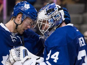 Toronto's Peter Holland, left, congratulates goalie James Reimer after their team defeated the Buffalo Sabres 4-2 in Toronto November 16 , 2013. (THE CANADIAN PRESS/Chris Young)