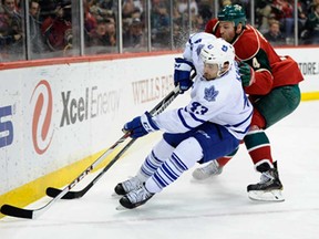 Toronto's Nazem Kadri, left, controls the puck against Minnesota's Clayton Stoner during the first period on November 13, 2013 at Xcel Energy Center in St Paul, Minnesota. (Hannah Foslien/Getty Images)