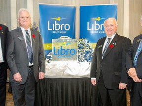 Libro Financial Group’s president and CEO Stephen Bolton. left, and board chairman Rick Joyal unveil the name and logo of the new Libro Credit Union, alongside United Communities Credit Union’s board chairman Dennis Hogan and president and CEO Jim Lynn.  (Courtesy of Libro Credit Union)