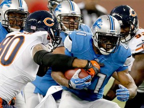 Chicago's Julius Peppers, left, grabs a hold of Detroit's Reggie Bush at Ford Field on September 29, 2013 in Detroit. The Lions travel to Chicago Sunday to face the Bears (1 p.m., Fox). (Gregory Shamus/Getty Images)