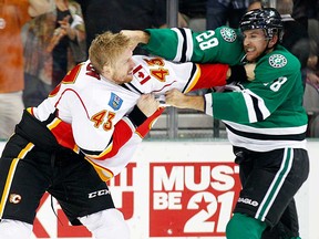 Former Spitfire Lane MacDermid, right, fights Calgary's Chris Breen in Dallas Thursday, Oct. 24, 2013. MacDermid was traded to the Flames Friday.  (AP Photo/The Dallas Morning News)