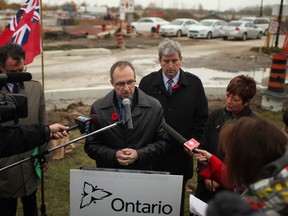 In this file photo, Steve Cripps, chief engineer with Ontario's Ministry of Transportation, answers questions while Glen Murray looks on, Nov. 1, 2013. (Dax Melmer / The Windsor Star)