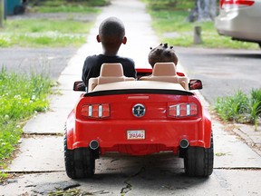 Ford is about to reveal its next generation Mustang (no that's not it) with a six-city worldwide blitz on Dec.6. As for the photo above, Antonio Garner Jr., 5, and Azariyah King, 1, rode in Antonio's Power Wheels Ford Mustang last May in Durham, N.C. "When he drives it every one honks and waves and girls ask him for a ride," said his mother, Shamika Lyons. (Christine T. Nguyen / Associated Press photo)