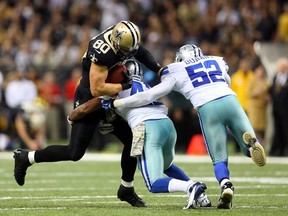 Saints tight end Jimmy Graham, left, is tackled by Cowboys free safety Barry Church, centre, and outside linebacker Justin Durant November 10, 2013 in New Orleans. (Ronald Martinez/Getty Images)