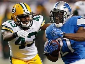 Detroit's Reggie Bush, right, tries to get around the tackle of M.D. Jennings of Green Bay at Ford Field on November 28, 2013 in Detroit. (Gregory Shamus/Getty Images)