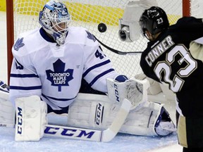 Pittsburgh's Chris Conner, right, lifts the puck over Leafs goalie Jonathan Bernier for a first-period goal in Pittsburgh, Wednesday, Nov. 27, 2013. (AP Photo/Gene J. Puskar)