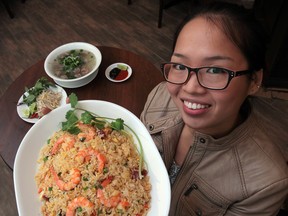 Tina Huynh, owner of Pho Maxim at 567 Pelissier St., Windsor, holds one of her soup dishes. (JASON KRYK / The Windsor Star)