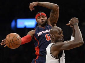 Brooklyn's Kevin Garnett, right, battles Detroit's Josh Smith at the Barclays Center on November 24, 2013 in the Brooklyn borough of New York City.    (TIMOTHY CLARY/AFP/Getty Images)