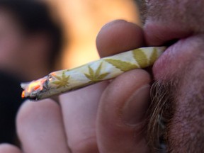A man smokes a marijuana cigarette. (Associated Press files)