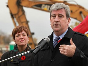Glen Murray, Minister of Transportation and Minister of Infrastructure, is joined by MPP Teresa Piruzza, Minister of Children and Youth Services, as they announce that the 500 girders being used on the Herb Grey Parkway project will be replaced, Friday, Nov. 1, 2013.  (DAX MELMER/ The Windsor Star)