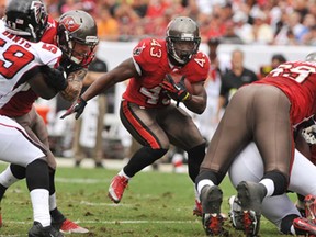 Tampa Bay running back Bobby Rainey, centre, rushes upfield against Atlanta November 17, 2013 at Raymond James Stadium in Tampa, Florida. (Al Messerschmidt/Getty Images)