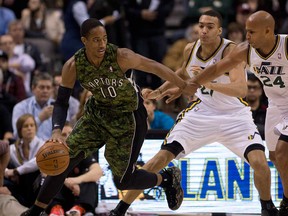 Raptors guard DeMar DeRozan, left, dribbles around Utah's Richard Jefferson, right, and Rudy Gobert  during NBA action in Toronto on Saturday November 9, 2013. (THE CANADIAN PRESS/Frank Gunn)