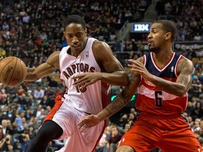 Toronto's DeMar DeRozan, left, drives against Washington's Eric Maynor  in Toronto on Friday November 22 , 2013. (THE CANADIAN PRESS/Chris Young)