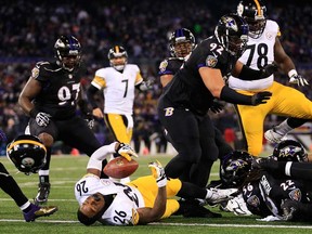 Pittsburgh running back Le'Veon Bell, centre, is stopped short of the goal line during the fourth quarter in a 22-20 loss to the Ravens November 28, 2013 in Baltimore. (Rob Carr/Getty Images)